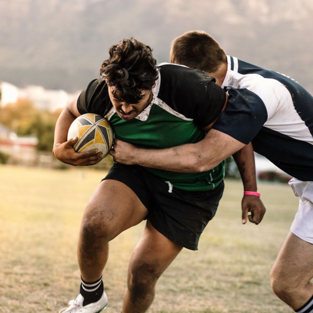young male atheletes compete for ball